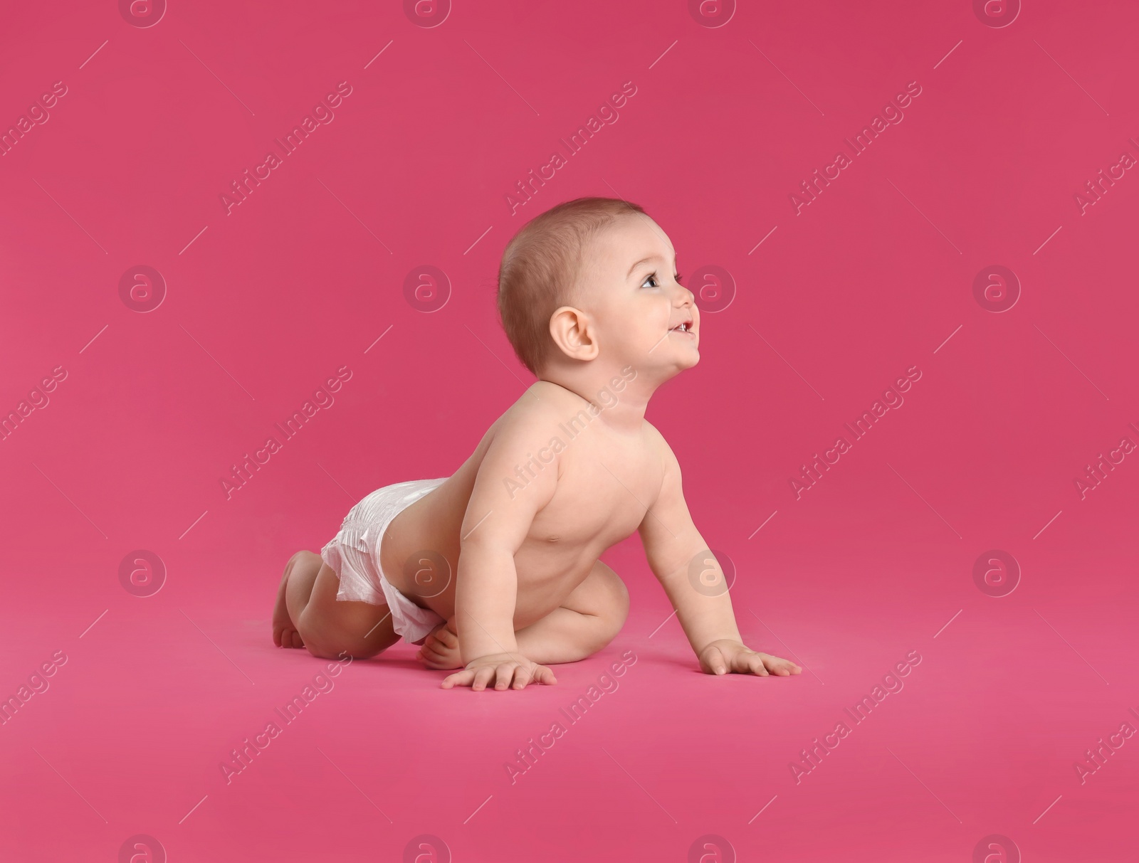 Photo of Cute little baby in diaper on pink background. Space for text