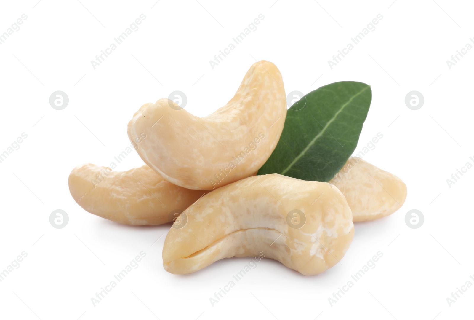 Photo of Tasty organic cashew nuts and green leaf isolated on white