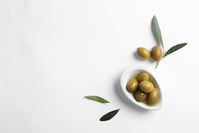 Flat lay composition with fresh olives in oil on white background