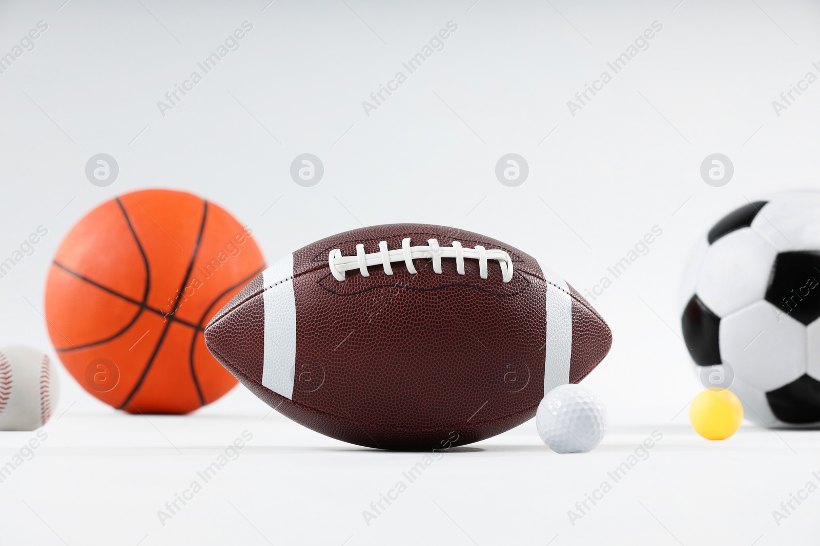 Photo of Many different sports balls on light gray background