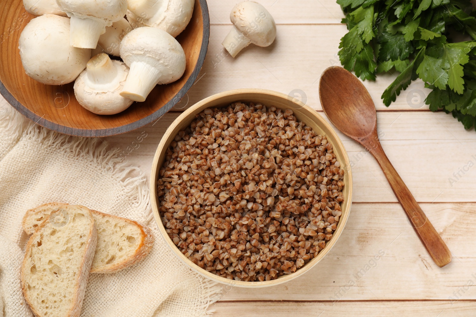 Photo of Tasty buckwheat in bowl on wooden table, flat lay