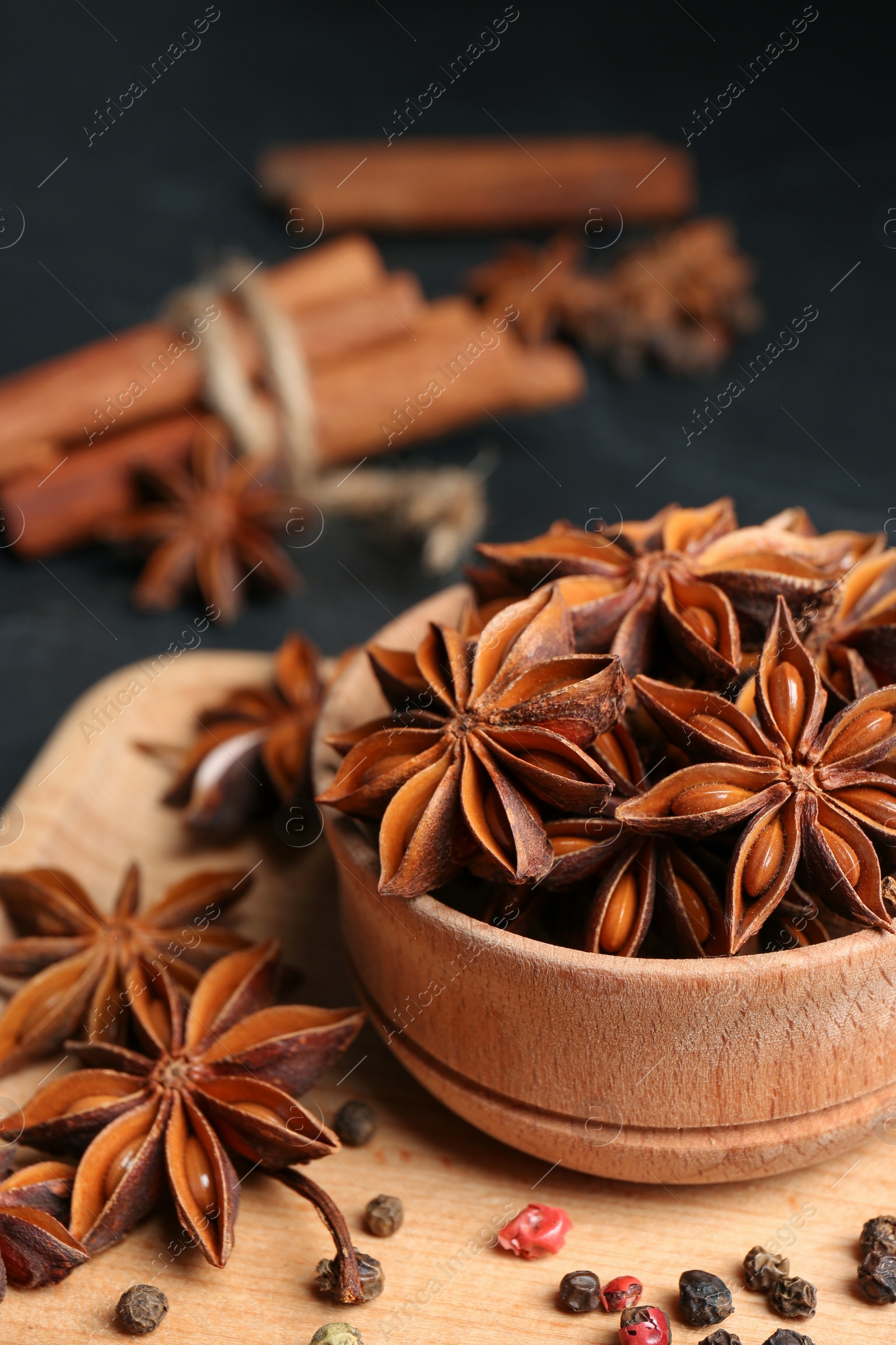 Photo of Aromatic anise stars and spices on tray, closeup