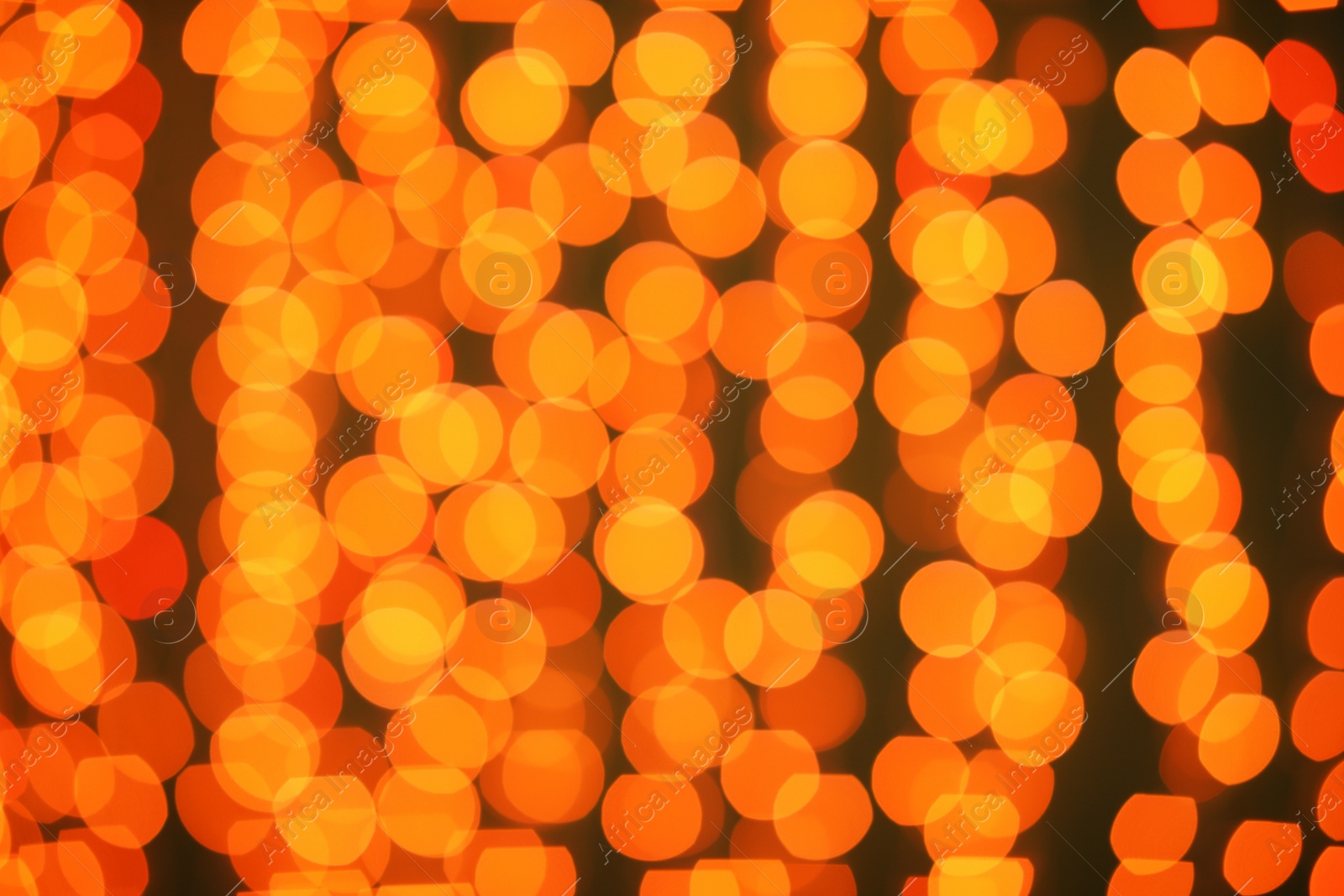 Photo of Beautiful gold lights on dark background. Bokeh effect