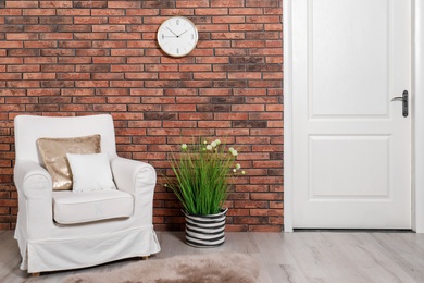 Photo of Modern room interior with white door and comfortable armchair