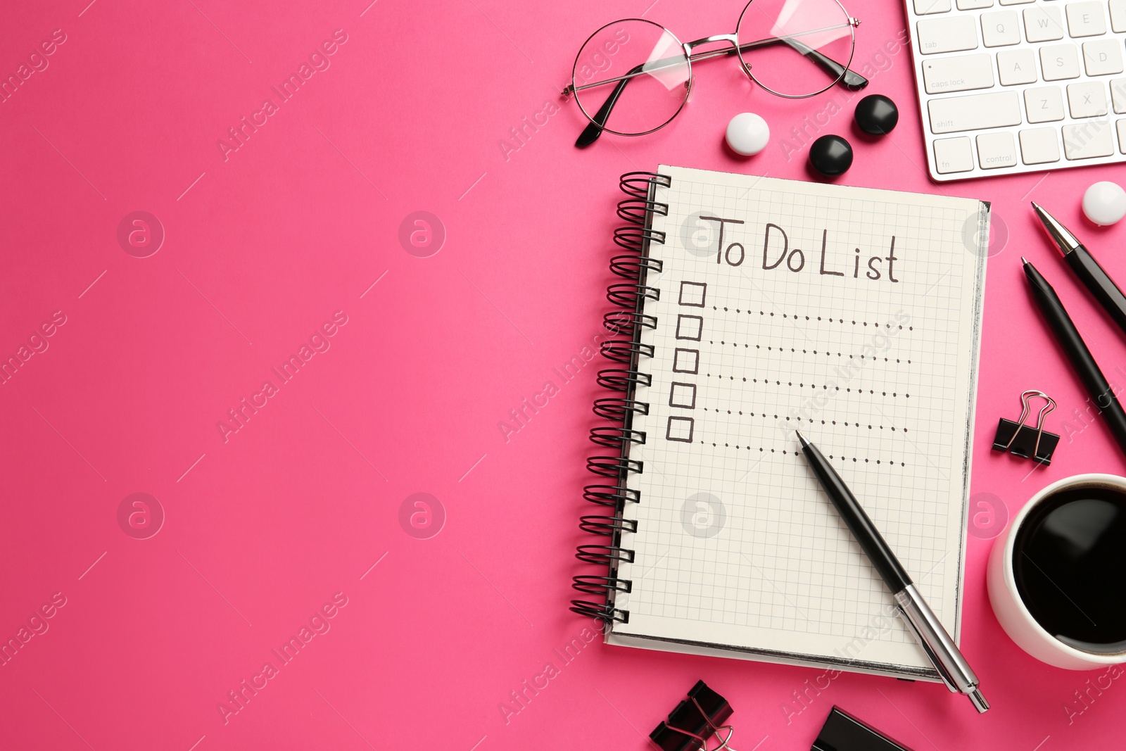 Photo of Flat lay composition with unfilled To Do list and cup of coffee on pink background, space for text
