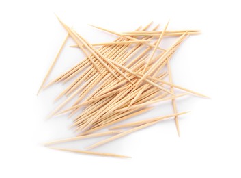 Heap of wooden toothpicks on white background, top view