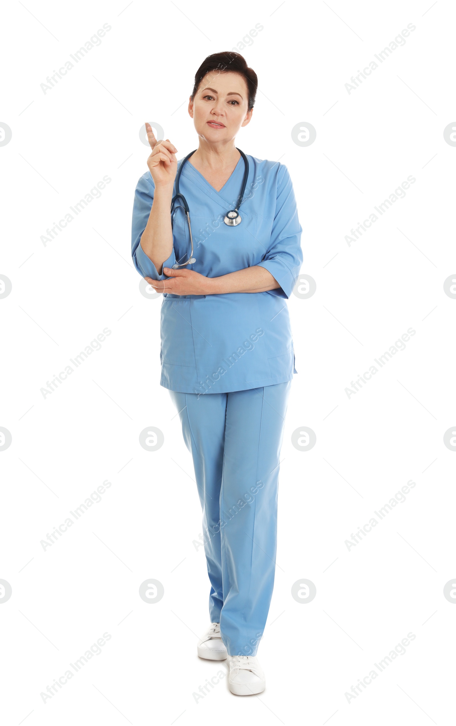 Photo of Full length portrait of female doctor in scrubs isolated on white. Medical staff