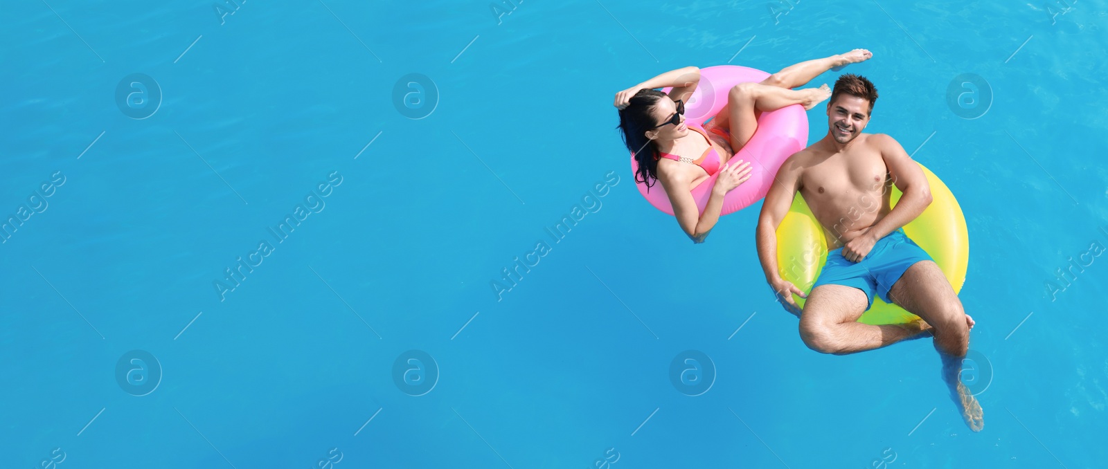 Image of Woman in bikini with boyfriend swimming at resort, space for text. Banner design