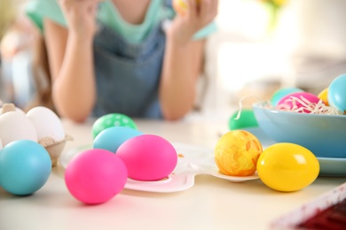Photo of Beautifully painted Easter eggs on white table indoors