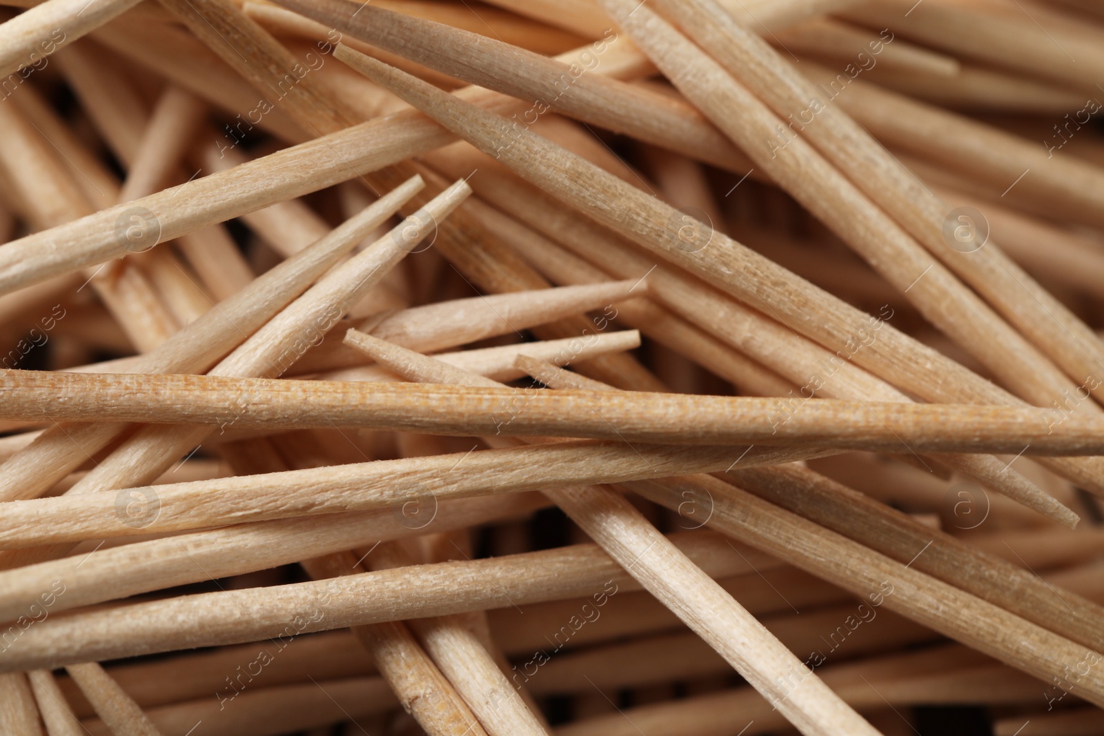 Photo of Disposable wooden toothpicks as background, closeup view