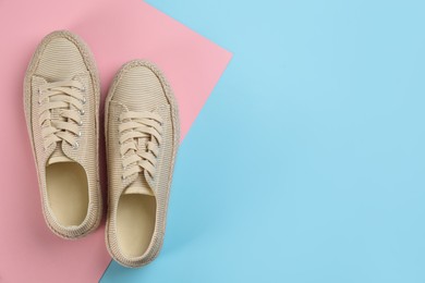 Pair of stylish sneakers on color background, flat lay. Space for text