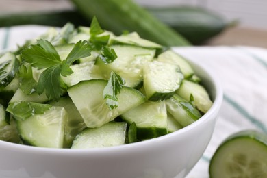 Photo of Delicious cucumber salad in bowl on table, closeup