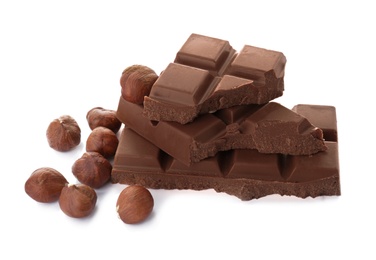 Photo of Delicious milk chocolate with nuts on white background