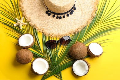 Flat lay composition with coconuts and beach objects on color background