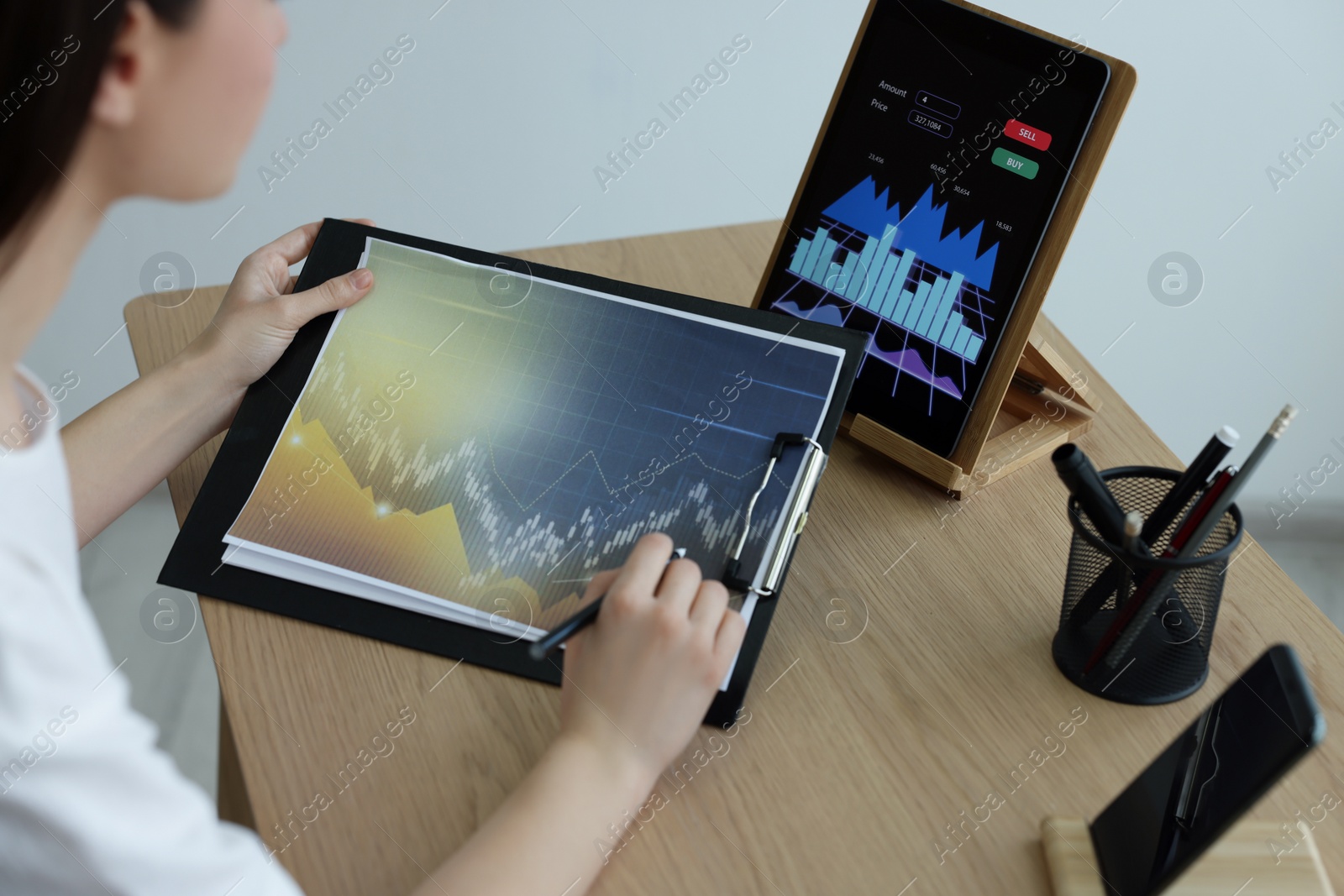 Photo of Businesswoman working with chart in office, closeup. Forex trading