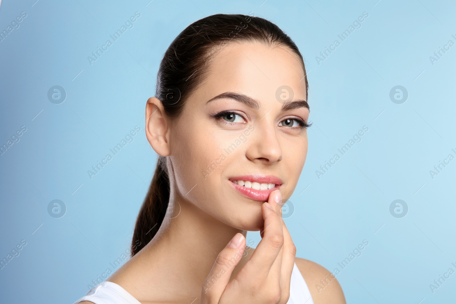 Photo of Young woman with sexy lips on color background