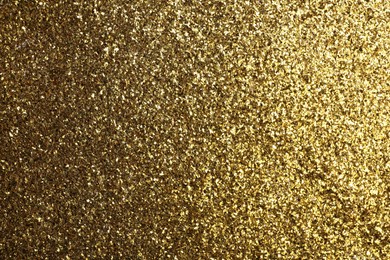 Photo of Beautiful shiny brass glitter as background, closeup