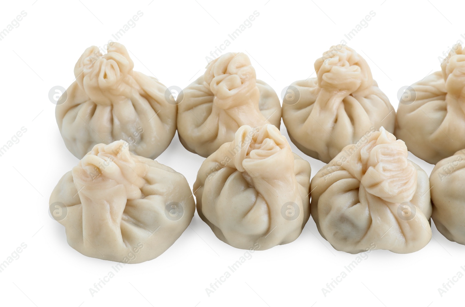 Photo of Many tasty khinkali (dumplings) isolated on white. Georgian cuisine