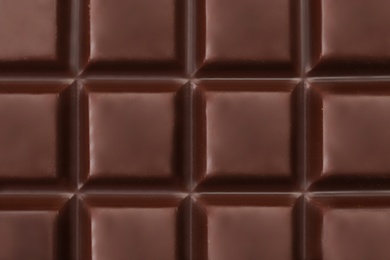 Photo of Delicious dark chocolate bar as background