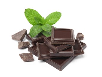 Tasty dark chocolate pieces with mint on white background