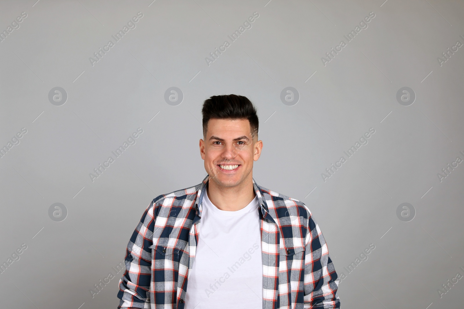 Photo of Portrait of happy man on light grey background. Personality concept