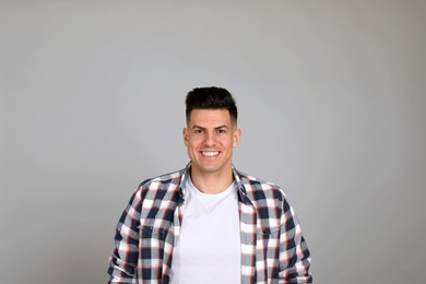Photo of Portrait of happy man on light grey background. Personality concept