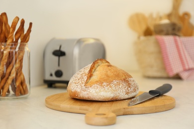 Loaf of bread and knife on counter in kitchen