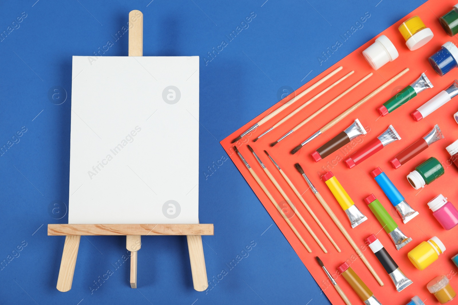 Photo of Flat lay composition with set of painting tools for children on color background