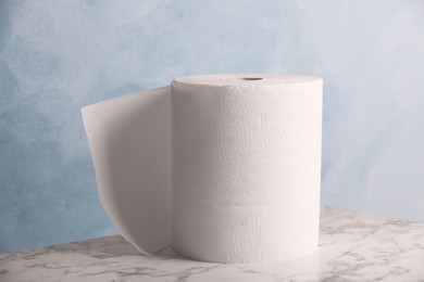 Photo of Roll of paper towels on white marble table