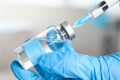 Doctor filling syringe with medication, closeup. Vaccination and immunization