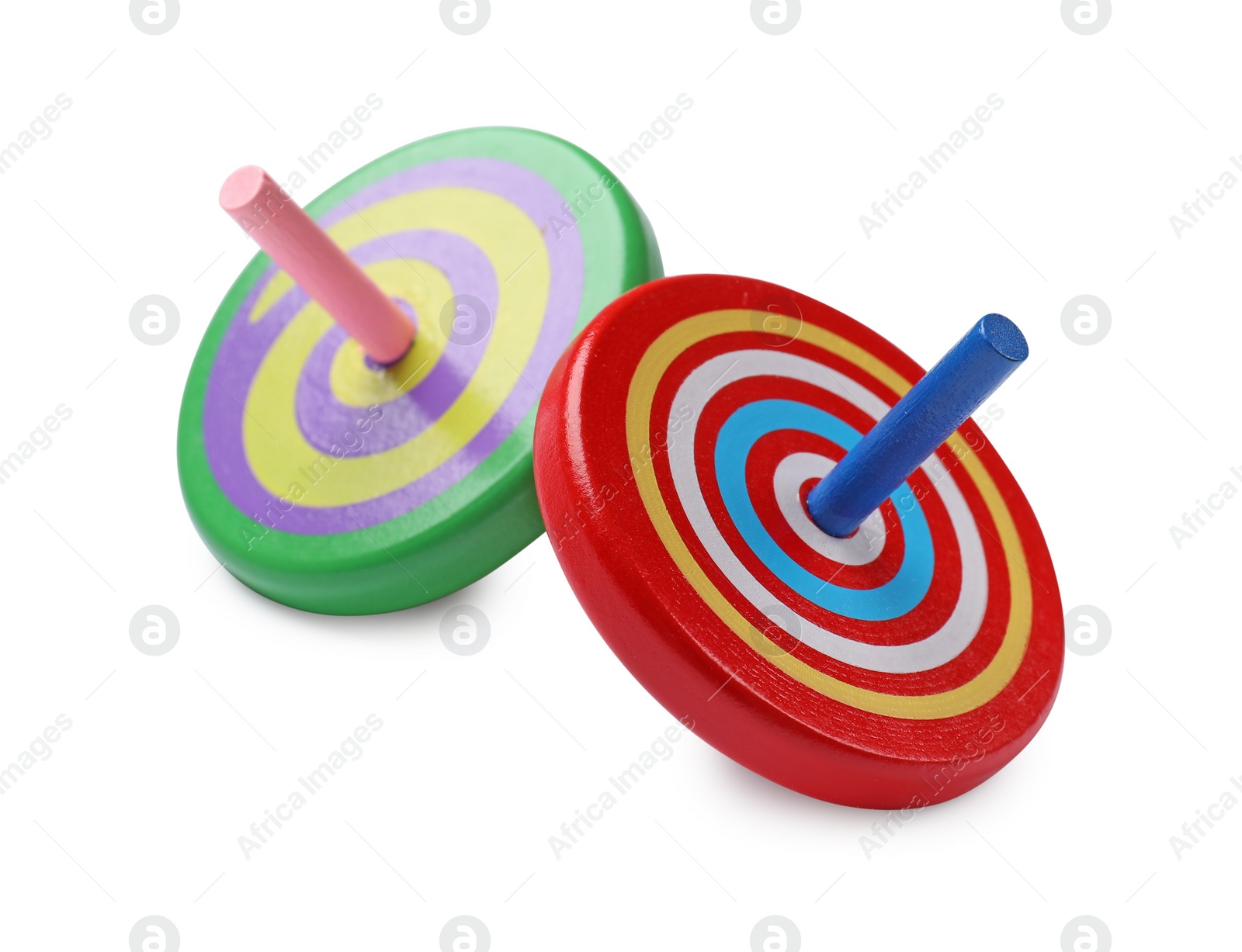 Photo of Two bright spinning tops isolated on white