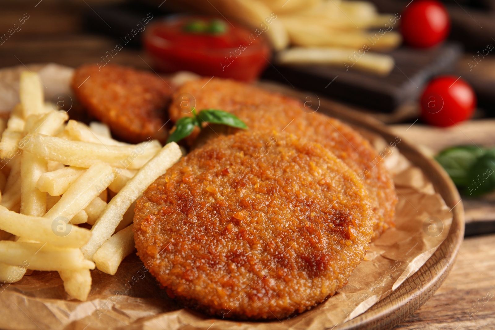 Photo of Delicious fried breaded cutlets served on wooden table, closeup