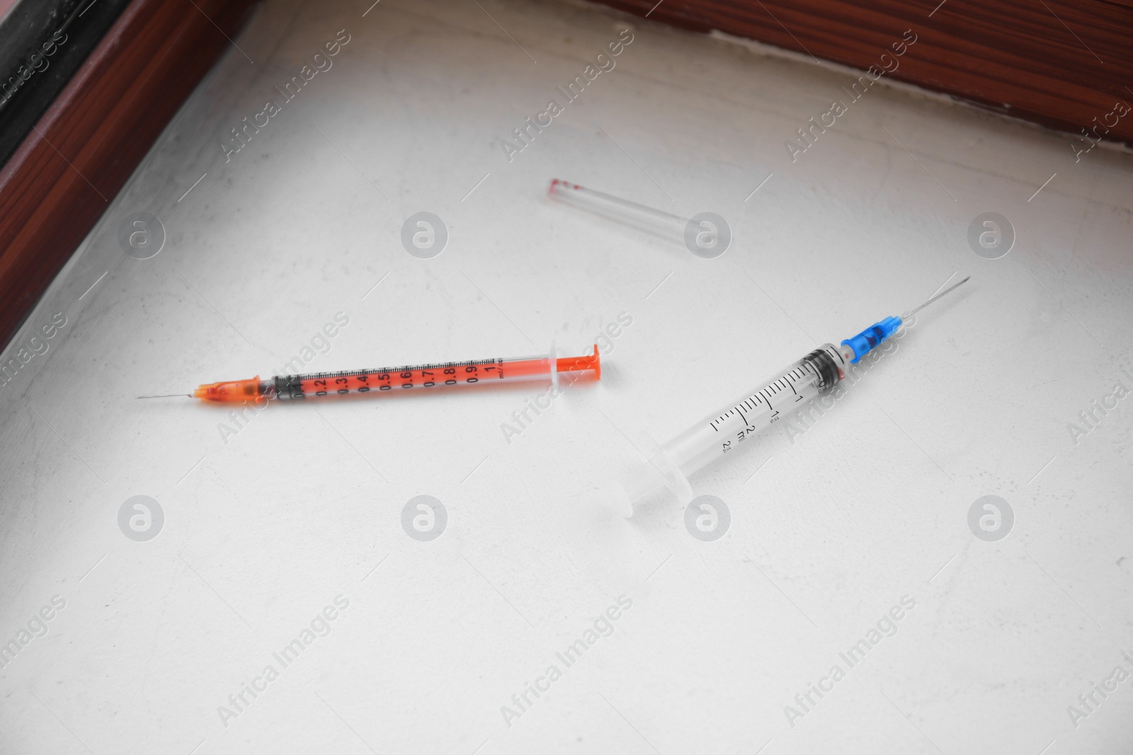 Photo of Disposable syringes with needles on white surface