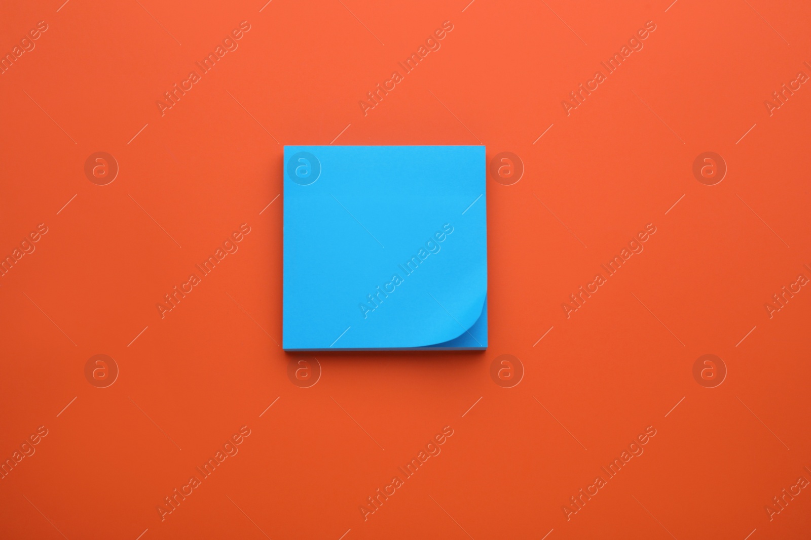 Photo of Paper note on orange background, top view