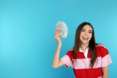 Young woman with money on color background. Space for text