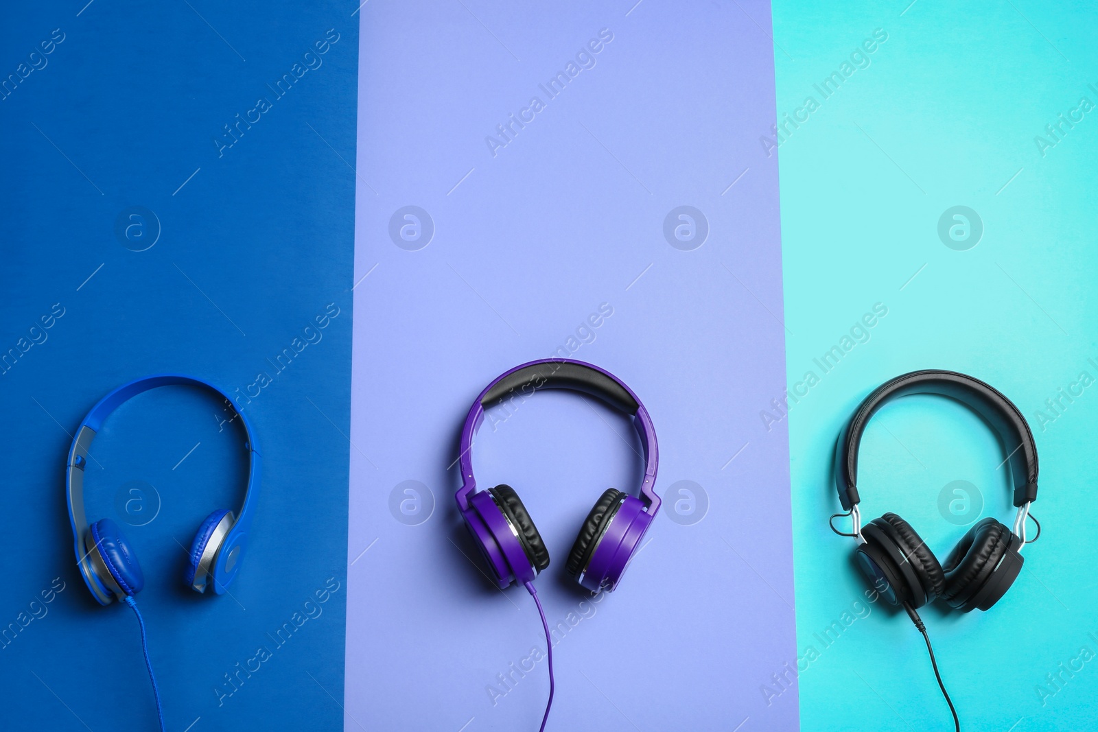 Photo of Stylish headphones on color background, flat lay. Space for text