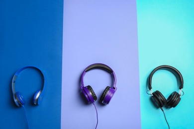 Stylish headphones on color background, flat lay. Space for text