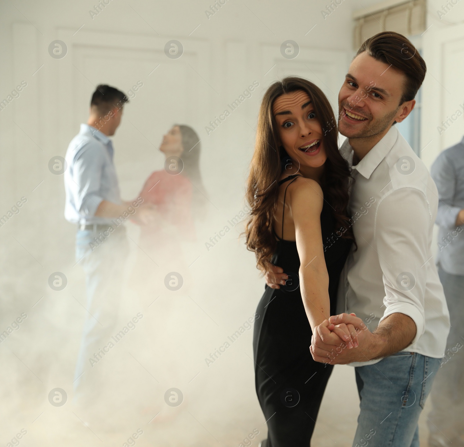 Photo of Lovely young couple dancing together at party