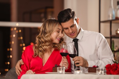 Lovely couple having romantic dinner on Valentine's day in restaurant