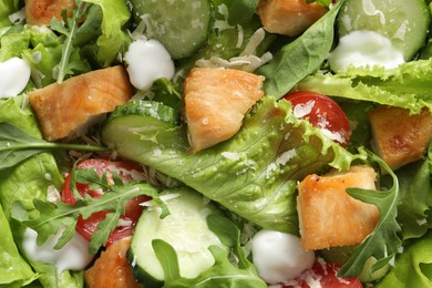 Delicious salad with chicken and vegetables as background, top view