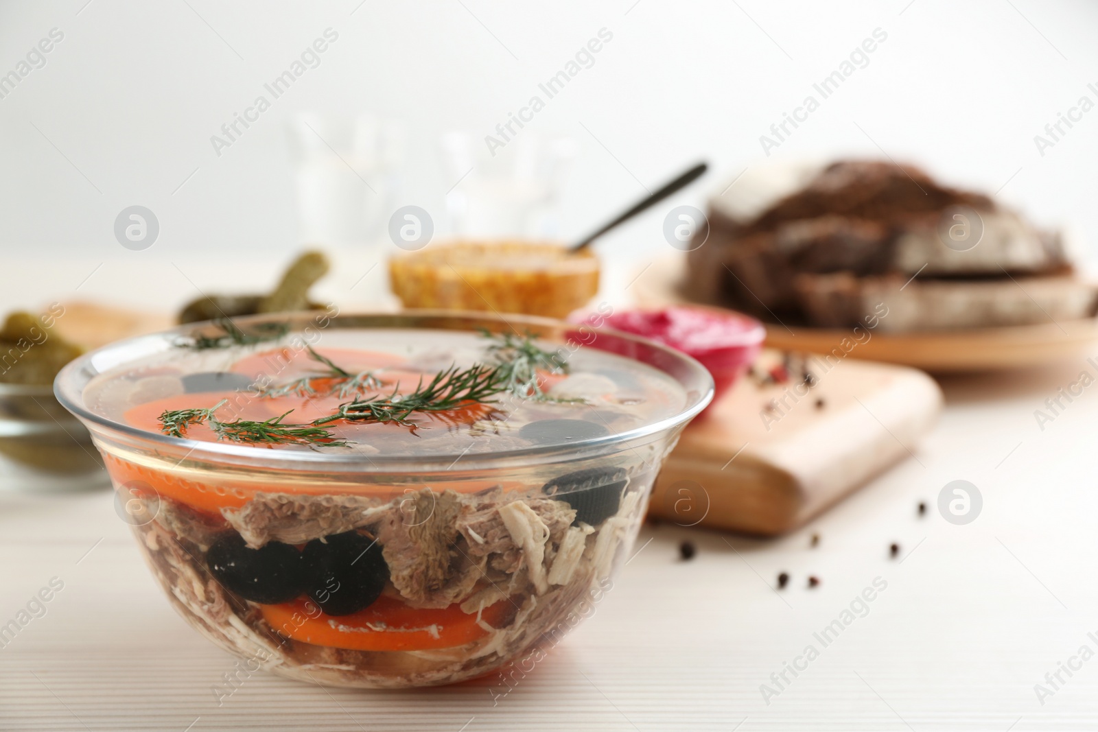 Photo of Delicious aspic with meat on white wooden table