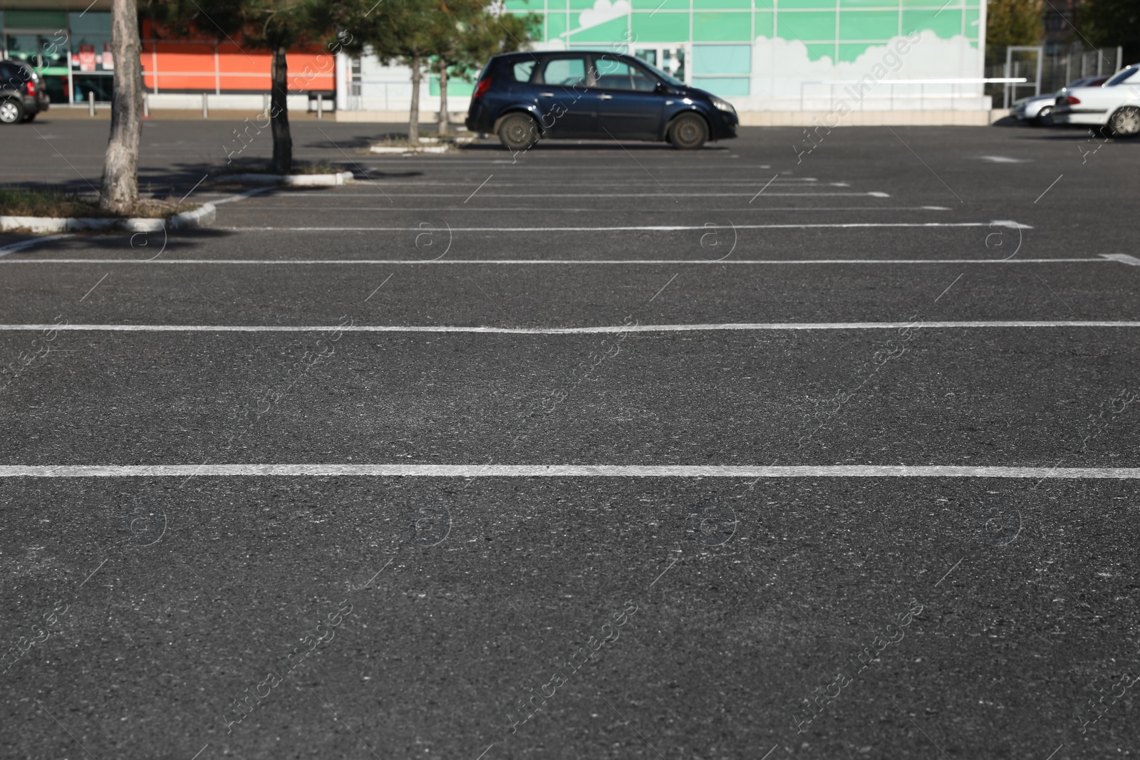 Photo of Car parking lot with white marking outdoors