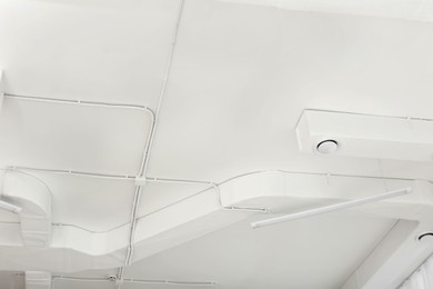 Photo of White ceiling with modern lighting in office