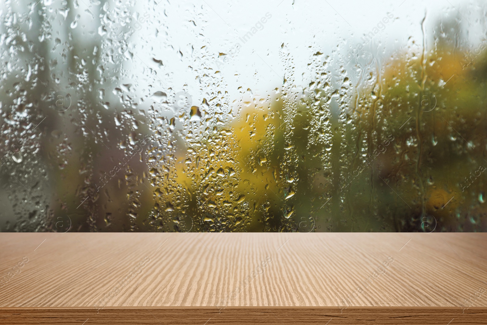 Image of Wooden table near window on rainy day