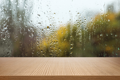 Image of Wooden table near window on rainy day