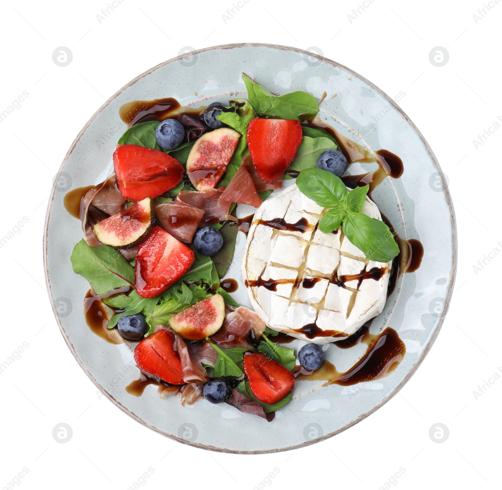 Photo of Plate of delicious salad with brie cheese, prosciutto, berries and balsamic vinegar isolated on white, top view