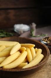 Photo of Fresh baby corn cobs on wooden table