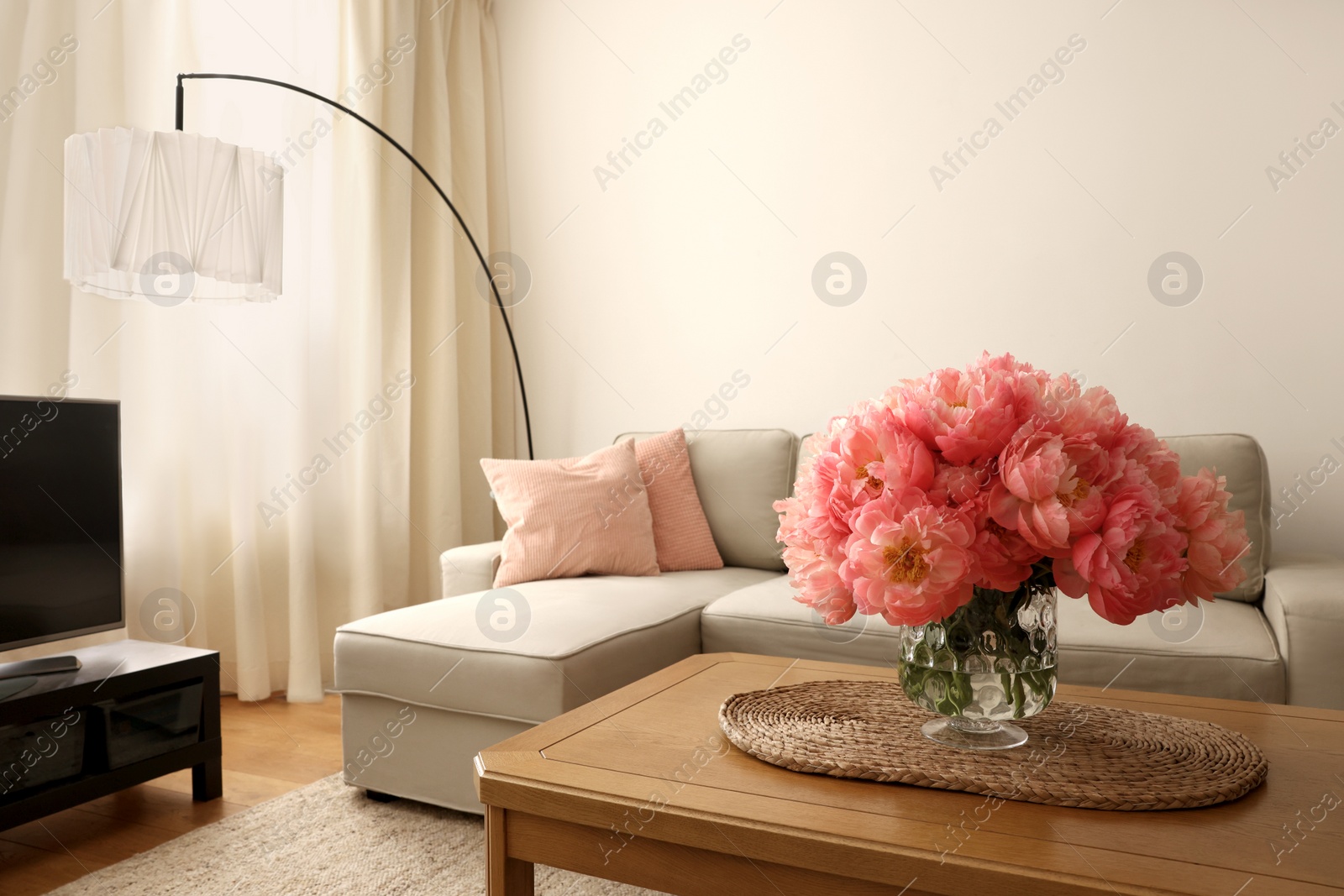 Photo of Beautiful pink peonies in vase on table at home, space for text. Interior design