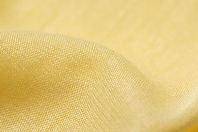Photo of Texture of bright yellow crumpled fabric as background, closeup