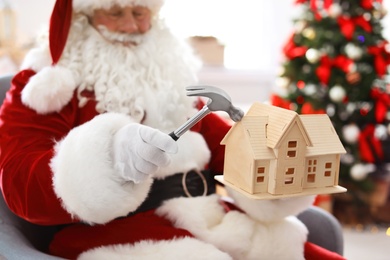 Photo of Authentic Santa Claus making toy in workshop